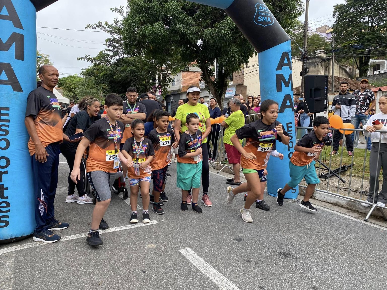 Crianças reunidas na rua para iniciar uma corrida